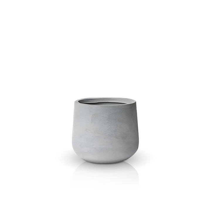 The Fortezza Planter - Small by Landmark Decor features a minimalist gray ceramic design with a smooth matte finish. Its simple, rounded shape and slightly irregular rim evoke handmade planters, seamlessly blending luxury and nature against a plain white background.