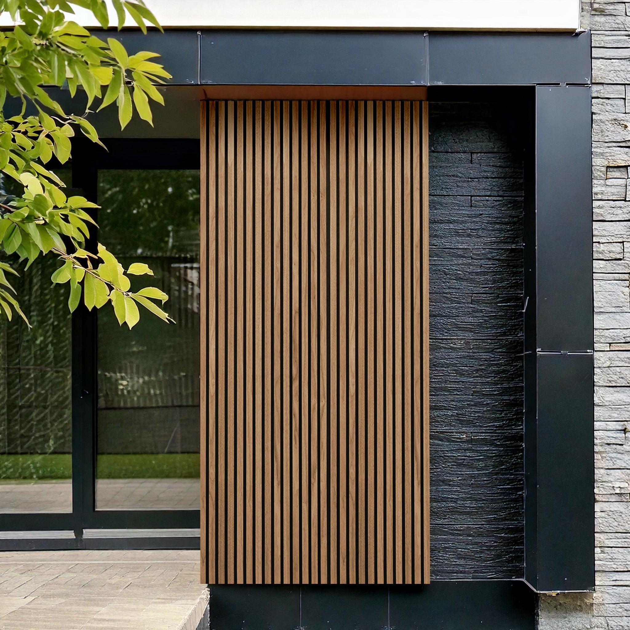 The facade features Landmark Decors Teak Color Exterior WPC Panels with vertical wooden slats, framed by dark metal. A textured stone wall adds to the weather-resistant design, while a large glass window blends seamlessly with nature, partially obscured by a leafy branch.