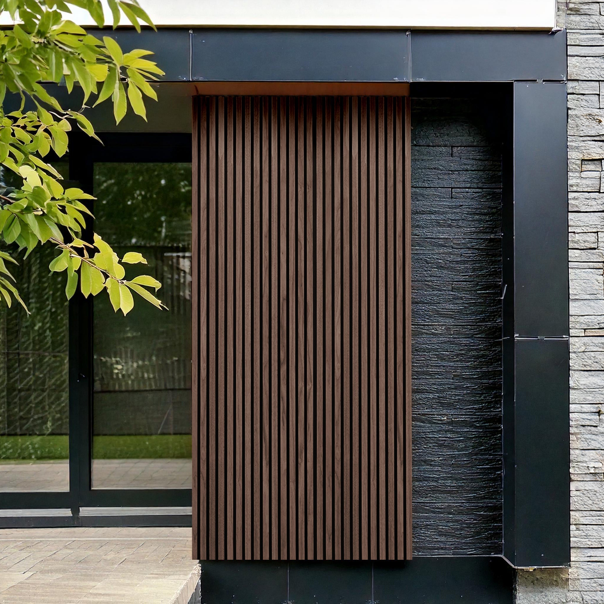 Landmark Decors Rosewood Exterior WPC Panels create a modern building facade with luxurious design, featuring vertical wooden slats, black steel frames, and gray stone elements. A large window reflects nearby greenery, contrasting naturally with the sleek architecture.