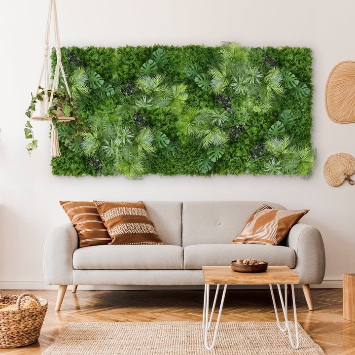 A cozy living room features a gray sofa with patterned cushions and a wooden coffee table with a bowl. The Tropical Green Wall mural from Landmark Decor adds vibrancy along with lush hanging plants, while wicker baskets enhance the decor and light wood flooring completes the fresh look.
