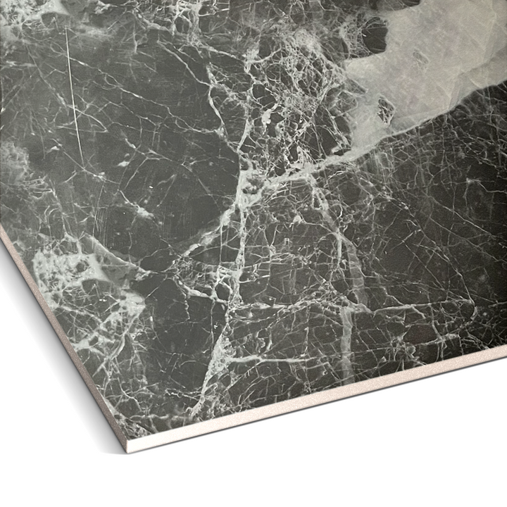 A close-up of the Landmark Decor Shadow Mist Marble durable PVC wall showcases its polished dark surface with prominent white veining, highlighting unique patterns and luxurious aesthetic that beautifully contrasts black and white elements.
