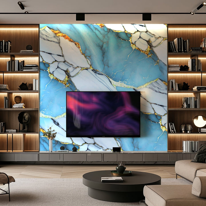 A modern living room features a large TV mounted on Landmark Decors Royal Azure Marble Durable PVC Wall, showcasing striking blue and gold veins, with wooden shelves holding books and decor items, embodying exquisite interior design.
