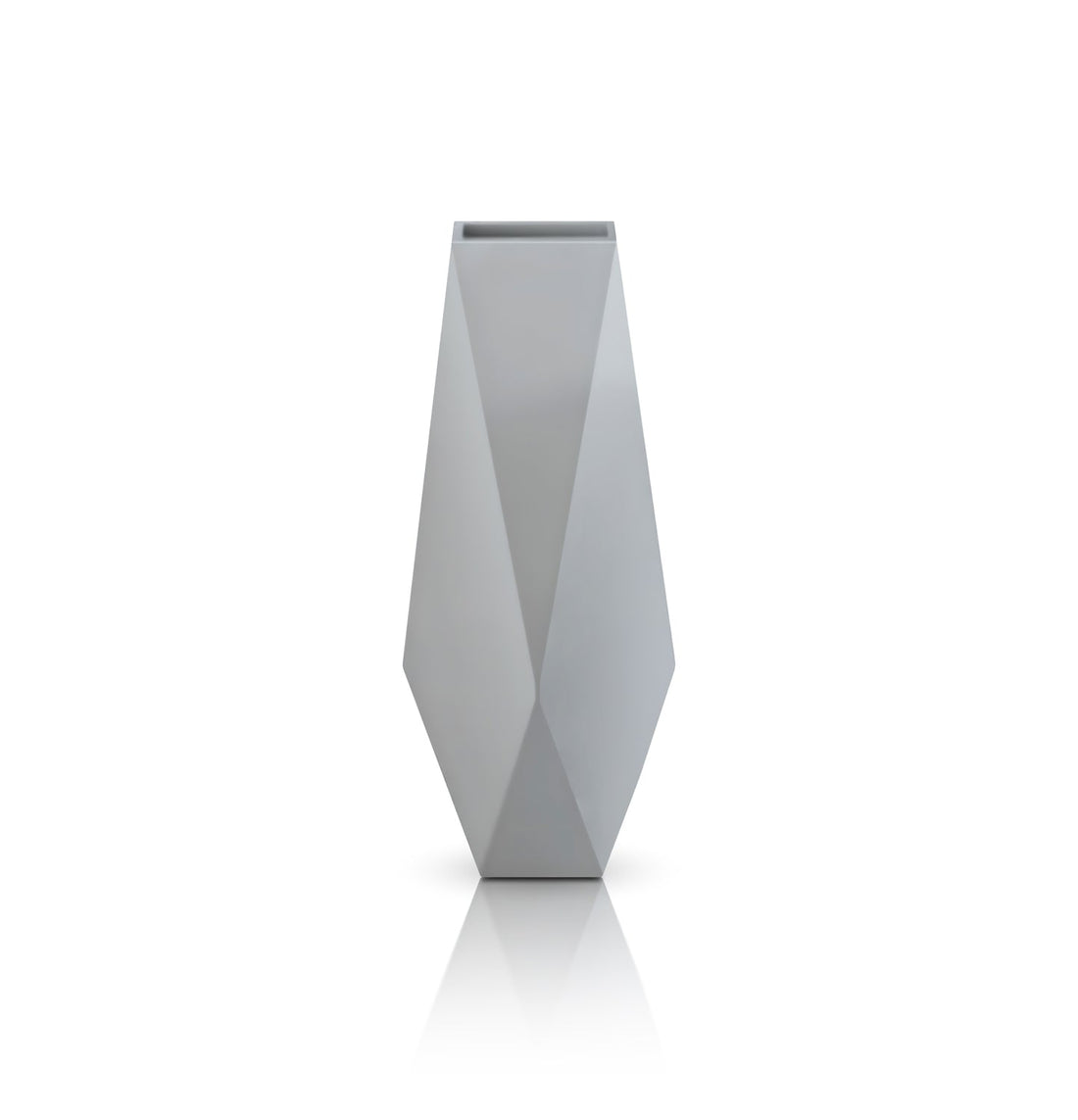 The Ombre Intrecciate Planter by Landmark Decor is a geometric, faceted gray vase with sharp angular sides set against a white background, featuring a luxury design akin to handmade planters and a reflective base for a modern, minimalist touch.