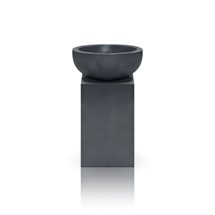 The Obelisk Planter by Landmark Decor is a modern, minimalist piece with a gray round bowl on a tall rectangular pedestal. Its sleek and simple design merges luxury and nature perfectly against a plain white backdrop.
