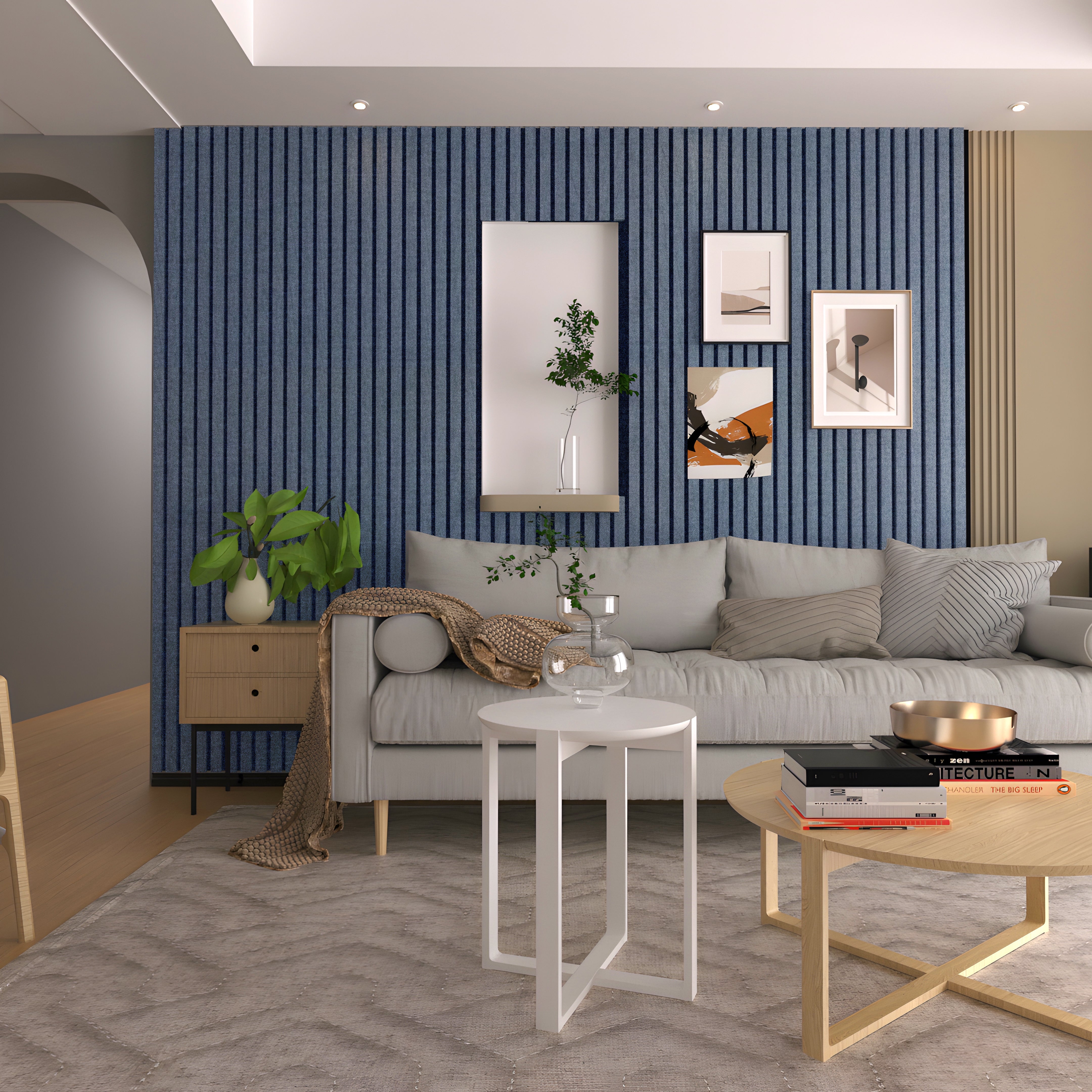 A modern living room boasts a Landmark Decor Navy Blue WPC fluted slat wall panel for style and soundproofing, along with framed art. A light gray sofa with cushions and a throw pairs well with a wooden side table plant, while two round coffee tables sit on a textured rug displaying decor.